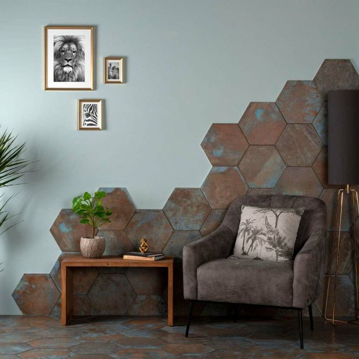 A living room featuring a stylish brown tiled wall and a single accent chair. 