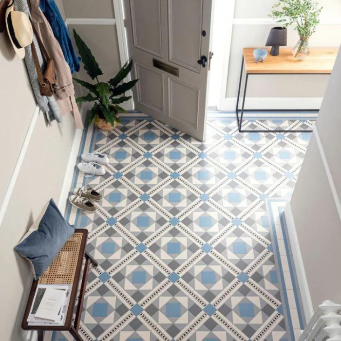 A stylish hallway with a captivating blue and white geometric tile design