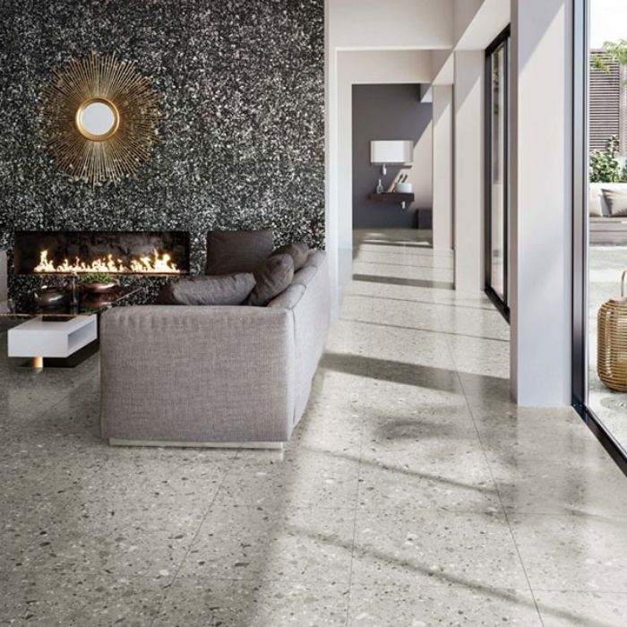 Modern living room with grey terrazzo floor tiles, fireplace, and large windows