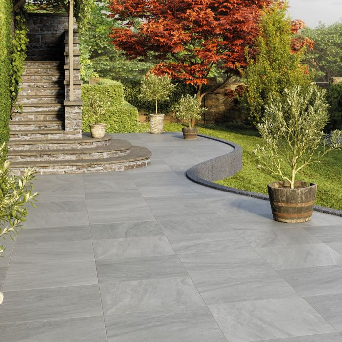 Outdoor grey tiled area with staircase and plant pots