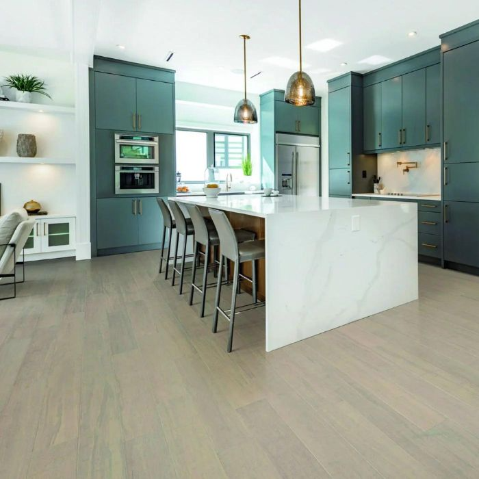 Modern kitchen featuring vibrant green cabinets and bamboo flooring