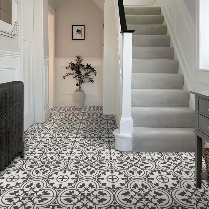 A long hallway features stylish white patterned floor tiles, creating a striking visual contrast