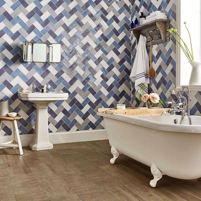 Blue and white herringbone tiled wall in bathroom