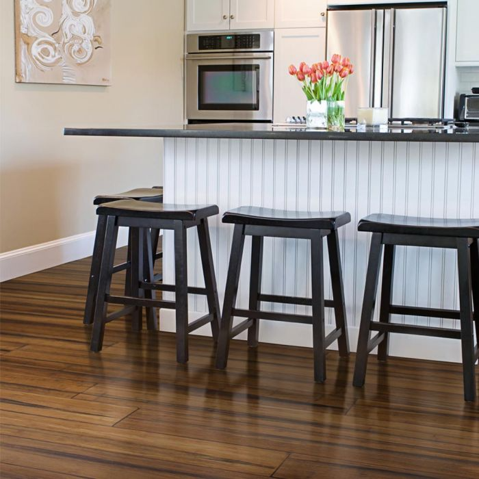 Kitchen with modern black stools on bamboo floors