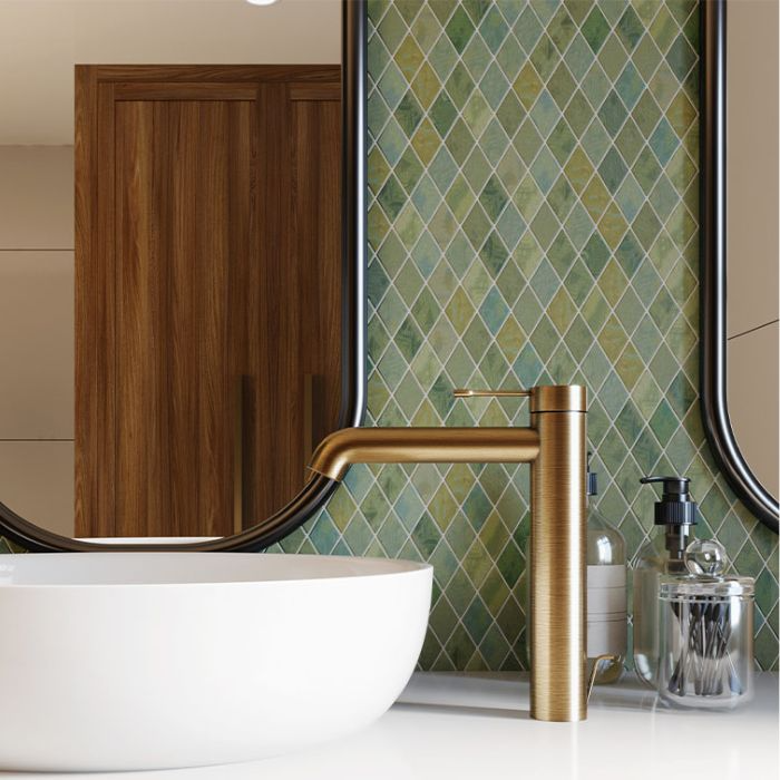 Green tiled wall with gold sink in modern bathroom