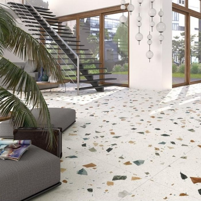 Spacious living room with white terrazzo floor tiles and a modern staircase