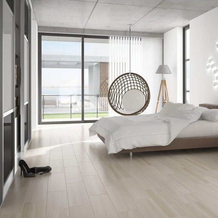 White walled bedroom featuring elegant wooden flooring