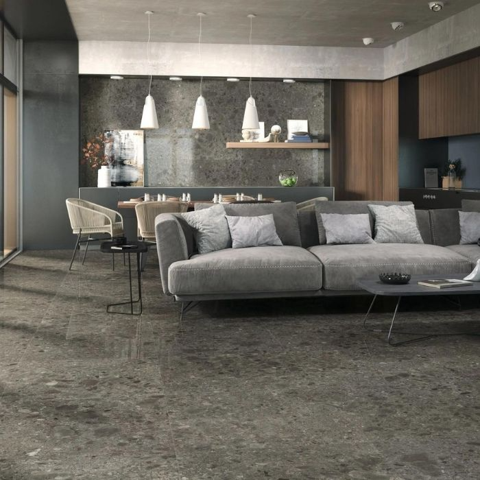 Stylish living room with dark terrazzo floor tiles and grey furniture