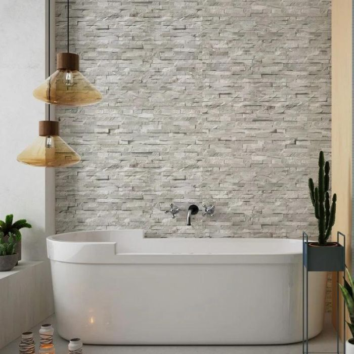 Clean, minimalist design in a bathroom with white tub and textured walls