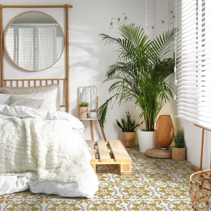 Serene bedroom ambience with mirror, bed, and potted plant