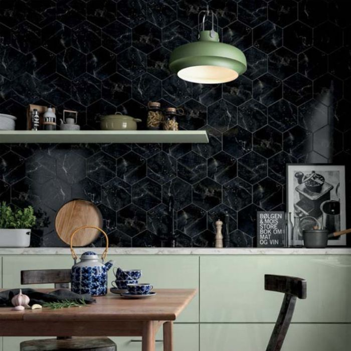 Stylish kitchen decor showcasing black hexagonal tiles paired with a green cabinetry