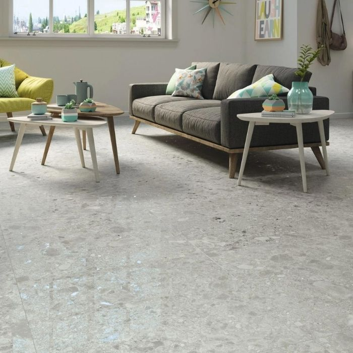 Living room with grey terrazzo floor tiles and colourful furniture