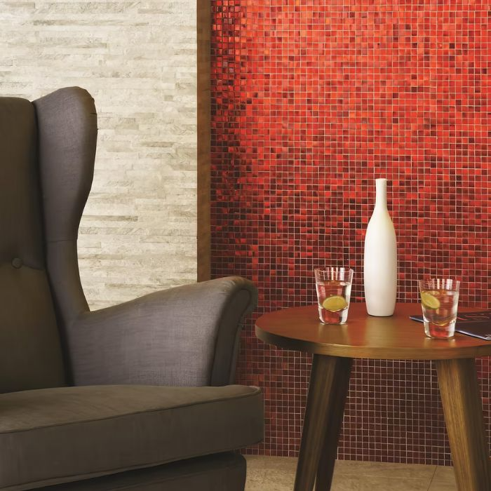 Stylish chair against vibrant red tiled wall