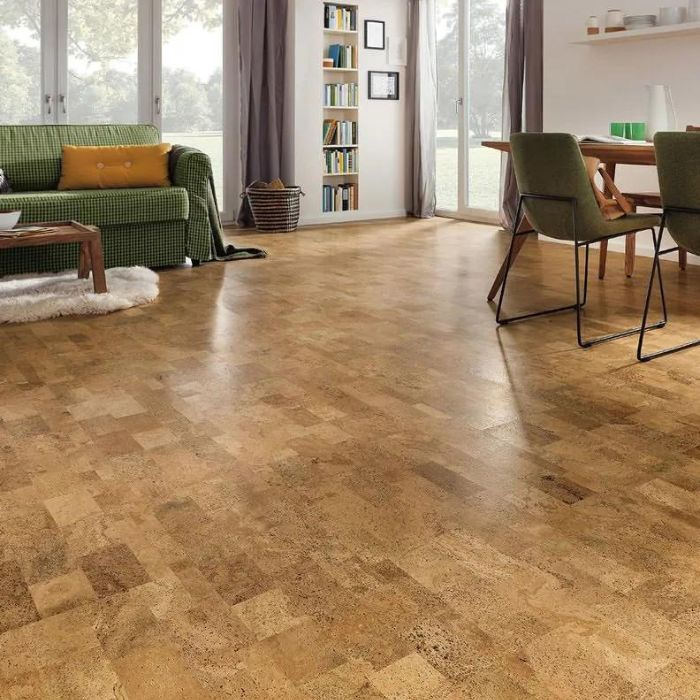 A close-up of textured cork flooring in a well-lit living room with a neutral colour palette