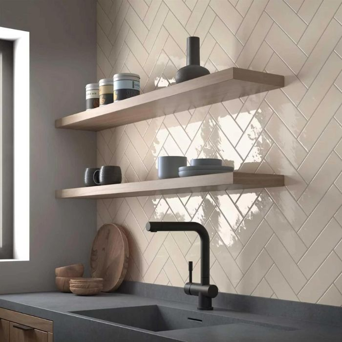 Kitchen interior featuring sleek herringbone subway tile backsplash and tidy shelves