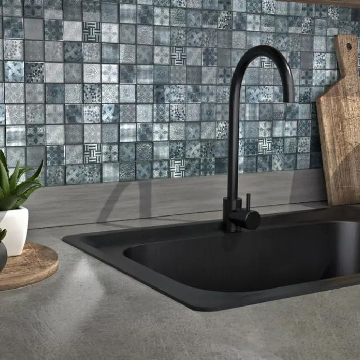 Contemporary kitchen with black sink and blue patterned mosaic tiles