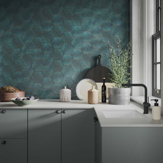 A modern kitchen featuring an eye-catching green hexagonal tiled wall