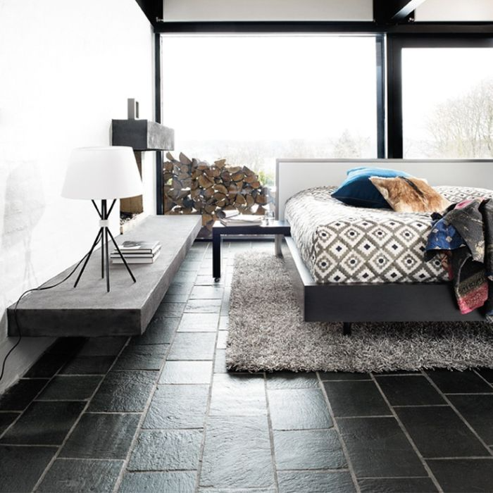 Contemporary monochrome bedroom design featuring slate floor tiles