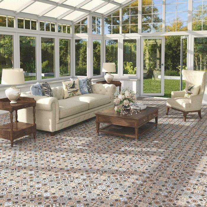 Sunroom-style living room with multicoloured patterned floor tiles