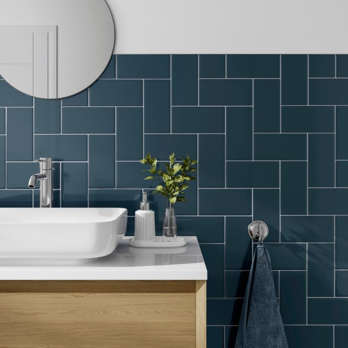 Cool-toned blue tiled wall in a sleek bathroom