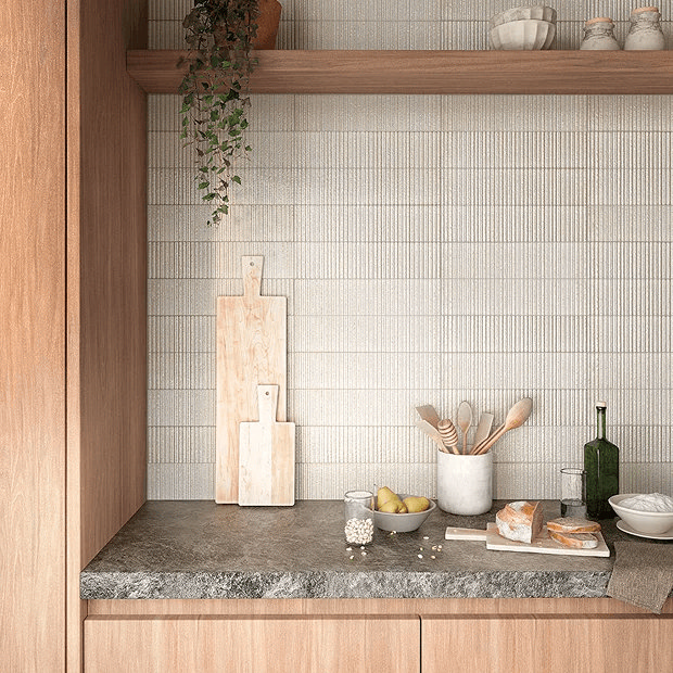 Kitchen with wooden counter and shelves against textured wall tiles