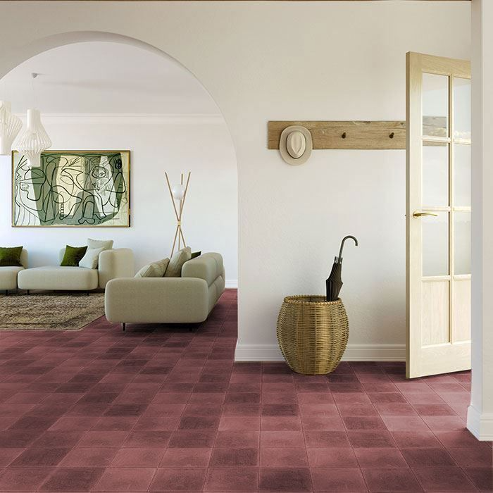 Warm and inviting living room with deep red encaustic tile flooring