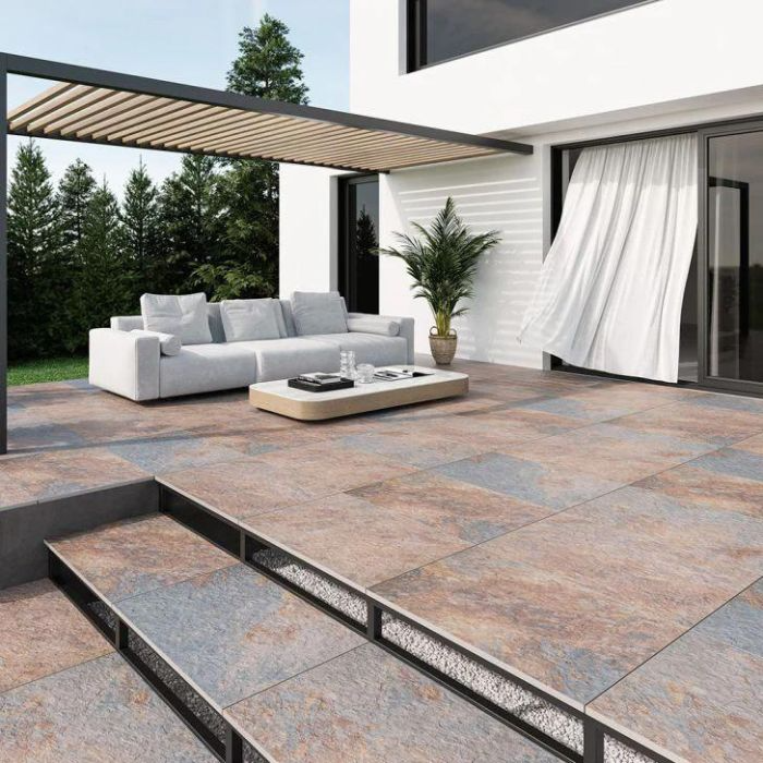 Relaxing outdoor lounge with chic sofa on tiled patio