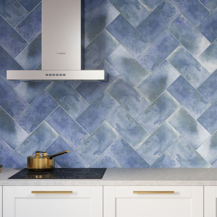 Vibrant blue tiles create a striking kitchen backdrop