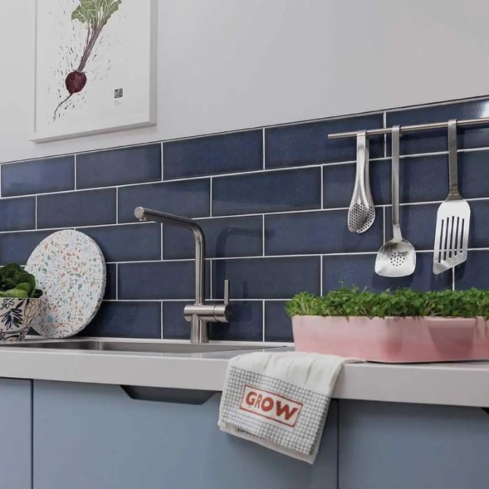 Blue and white kitchen with sleek subway tiles