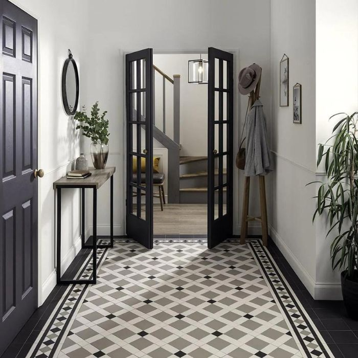 A spacious hallway showcasing a bold black and white tile pattern