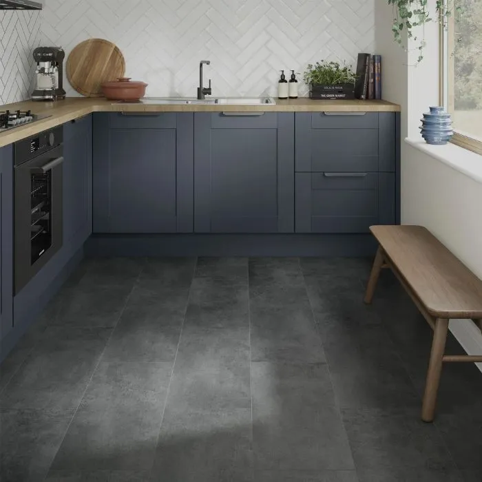 Minimalist kitchen with wooden bench on anthracite tile floor