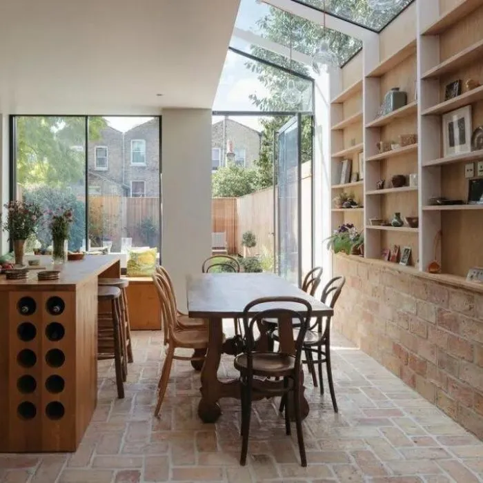 Wooden furniture set in a charming dining room with textured brick walls