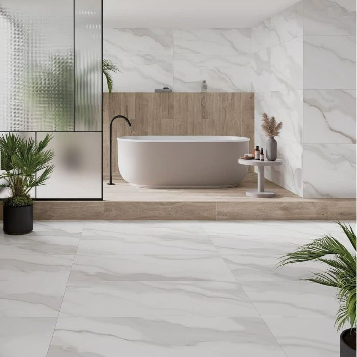 Luxurious white marble bathroom with a freestanding tub