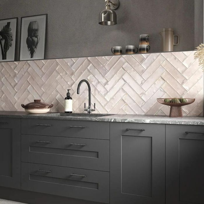 A stylish kitchen featuring a herringbone tile backsplash that adds a touch of elegance