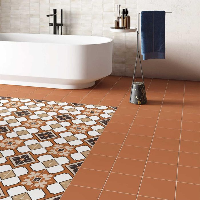 Bathroom interior featuring stylish terracotta flooring and a tub