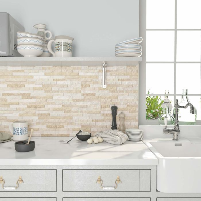 White kitchen with sink, countertops, and textured wall tiles