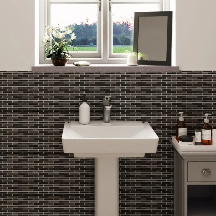 Contemporary bathroom design featuring striking black and white bathroom tile ideas and a white sink