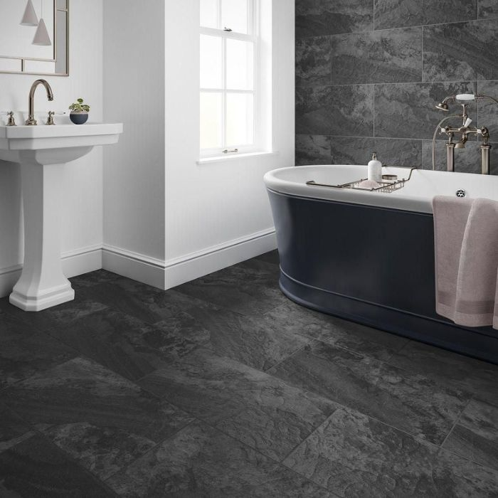 An elegant bathroom with black tiles and white walls