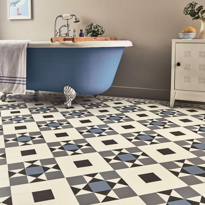 Blue and white geometric tiled bathroom floor