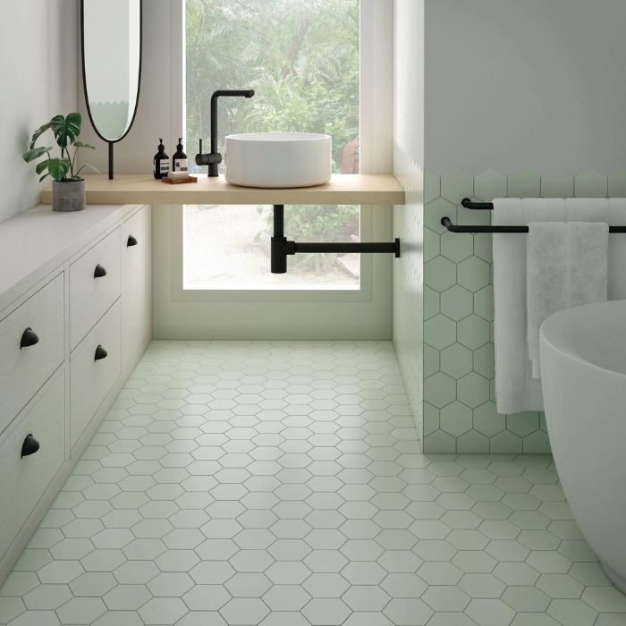 Modern bathroom featuring vibrant green hexagon tiles