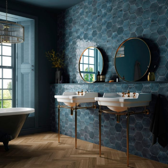 Sleek blue green hexagon tiled bathroom with double sinks