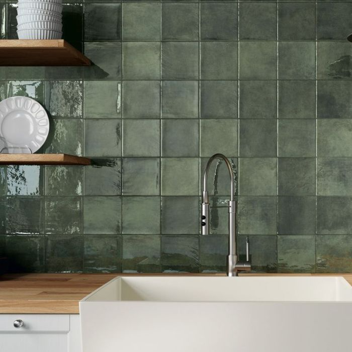 Kitchen with vibrant green tiled wall and sink