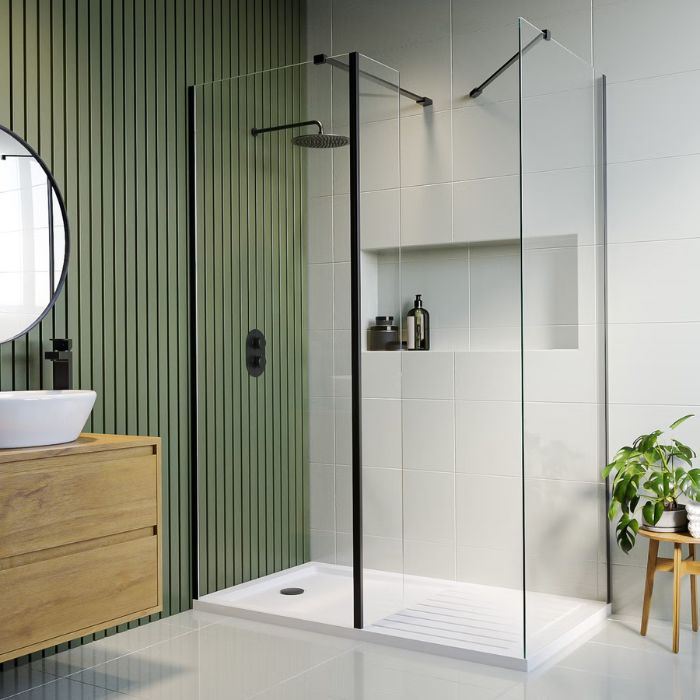 Stylish bathroom featuring green walls and transparent shower enclosure