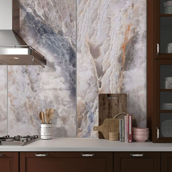 A sleek kitchen with intricate marble backsplash