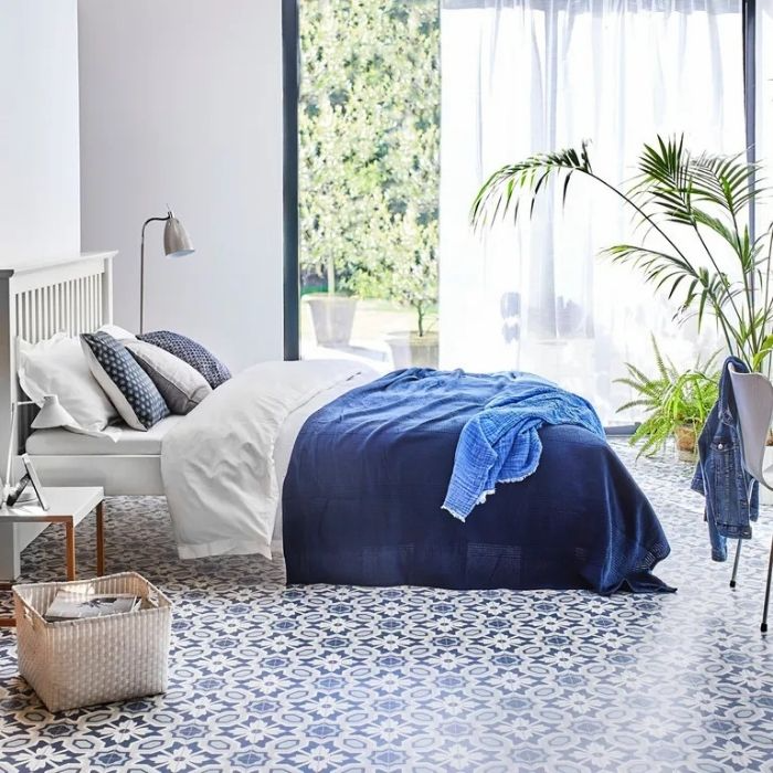 A charming bedroom adorned with unique blue and white patterned tiles 