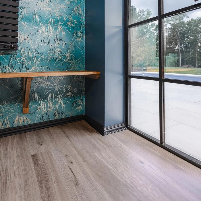 Charming room adorned with blue wallpaper and beautifully polished wood floors