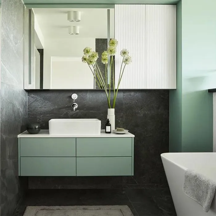 Charcoal bathroom tile ideas with white sink and green accents