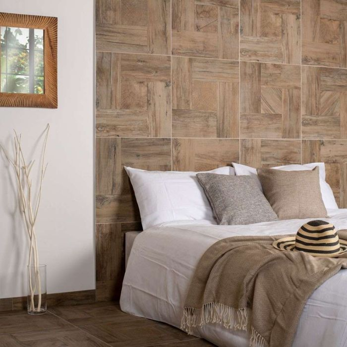 A cosy bedroom featuring a wooden wall and a neatly made bed