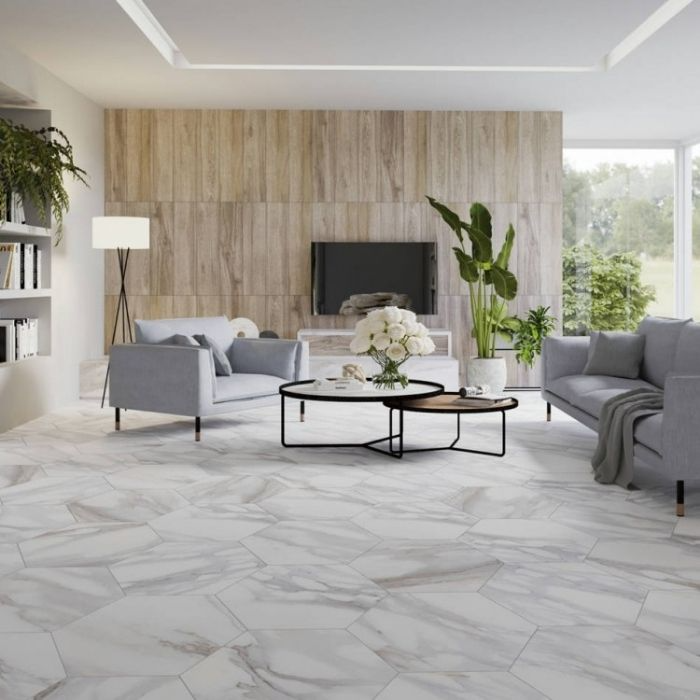 Living room with large white marble-effect hexagon floor tiles and grey sofas