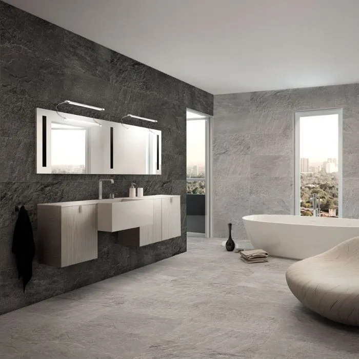 Elegant bathroom with large grey-tiled walls and a luxurious tub